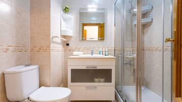 Bathtub, hair dryer, shampoo, toilet paper