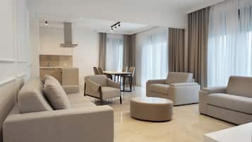 Junior Suite, 2 Bedrooms | Living area | 55-inch Smart TV with cable channels, TV