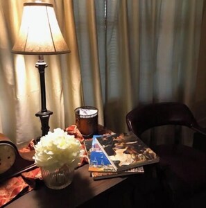 Enjoy a meal in this inviting space with a table set for two, a comfortable chair, and a beautiful view.