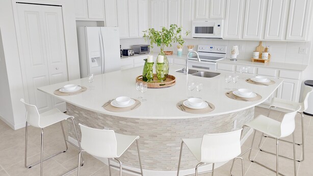 A modern kitchen with white cabinetry, a central island with seating, and a microwave above the stove. - Lovely Villa at Kissimmee (Kissimmee)