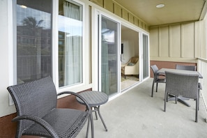 Relax in a, enclosed space with a seating area and glass door leading to a quiet interior room.