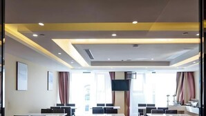 A hotel room with a large bed, a desk, and a chair. There is a window with curtains, and a door with a handle. - Greentree Inn Jiangsu Zhangjiagang Jingang Town Darunfa Express Hotel (Suzhou)