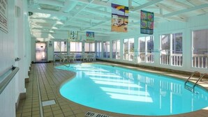 An indoor swimming pool with a 'NO DIVING' sign, tiled floor, and large windows. - Outer Banks Beach Club II - 1BR/1BA - Great Pools! (Kill Devil Hills)