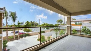 A balcony with a view of a parking lot and neighboring buildings. - Cardiff 5 bedroom home w/pool &  gated driveway near beach (Encinitas)