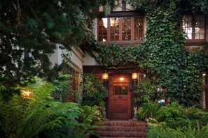 A house with a wooden front door, a small porch, and a window above the door. - Old Monterey Inn (Monterey)