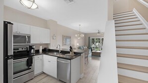 A modern kitchen with stainless steel appliances, a dishwasher, and a central island with a sink. - Villa 5028 on Duck Key Boat Slip Available - 2BD 2.5BA (Duck Key)