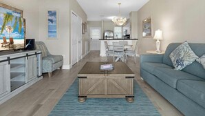 A living room with a coffee table, sofa, and a dining area with chairs. - Villa 5028 on Duck Key Boat Slip Available - 2BD 2.5BA (Duck Key)