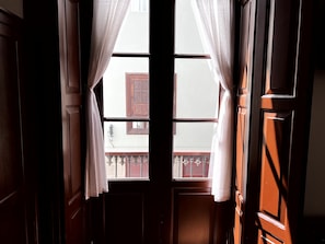 Habitación triple de diseñador, balcón, vista a la ciudad | Tabla de planchar con plancha, cuna de viaje y wifi gratis