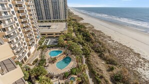 A resort with a pool area, beachfront, and high-rise buildings. - $150 activities - E-gift card when you book - Oceanfront | Wrap-Around Balcony | M902 (Myrtle Beach)