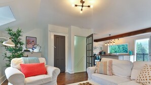 A modern living room with a white sofa, a coffee table, and a plant. - Charming 2 bedroom rental unit in Knowlton village (Knowlton)