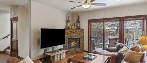 Smart TV, fireplace, books, printers