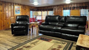 A cozy living room with a leather sofa, two armchairs, and a wooden coffee table. - Coyote - Upper Canyon w Priv Hot Tub, Big Decks, Wood Fireplace (Ruidoso)