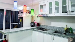 Villa | Private kitchen | Coffee/tea maker, electric kettle, paper towels, dining table - PHILDOTCOM ROYAL VILLA (Bacolor)