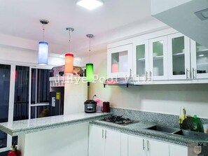 Villa | Private kitchen | Coffee/tea maker, electric kettle, paper towels, dining tables - PHILDOTCOM ROYAL VILLA (Bacolor)