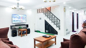 Villa | Living area | 50-inch Smart TV with cable channels, TV, DVD player - PHILDOTCOM ROYAL VILLA (Bacolor)