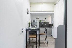 A compact kitchen with a dining area, a microwave, a sink, and a small plant. - GuestHost - Cozy and modern apartment of about 40 sq m, able to accommodate up to 3 people, located on the 1st floor of a renovated building with no lift. The property is located in the center (NO ZTL - Traffic Restricted Area), just a 5-minute walk from (Palermo)