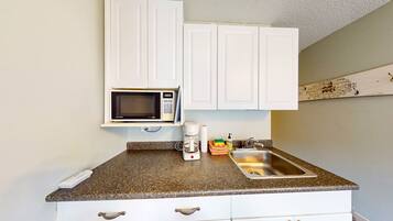 Fridge, microwave, coffee/tea maker, cookware/dishes/utensils