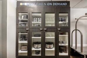 Ein Küchenschrank mit mehreren Fächern, darunter Regale für Geschirr und Küchengeräte.