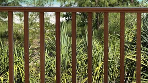 A wooden balcony railing overlooking a beach with pine trees and a view of the ocean. - Kivuli Beach Resort Paje (Paje)