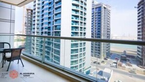 A high-rise building with multiple balconies, a view of the cityscape, and a clear sky. - Charming apartment in Sport city (Dubai)