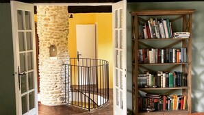 A room with a stone wall, a wooden bookshelf, and a staircase. - Mastignac (Valreas)