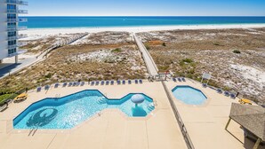 A resort with a pool, beach view, and a boardwalk. - Phoenix 8 Beachfront Condo! (Orange Beach)