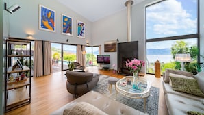 A spacious living room with a fireplace, large windows, and a view of the outdoors. - Best Villa with Pool & Panoramic views (Lutry)