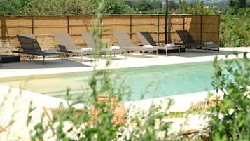 Seasonal outdoor pool, open 9:00 AM to 8:00 PM, pool loungers