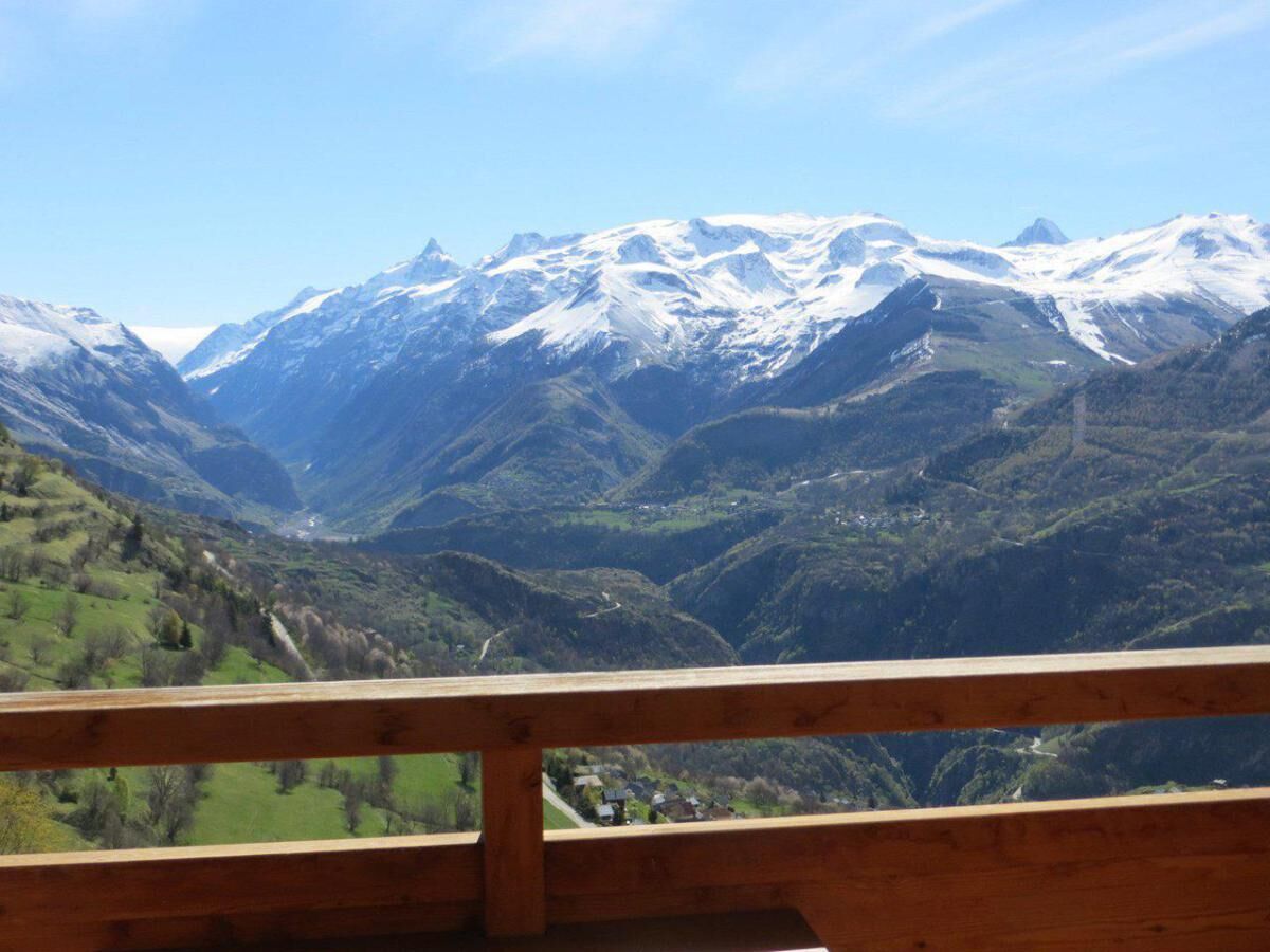 A mountain landscape with snow-capped peaks and a valley below.