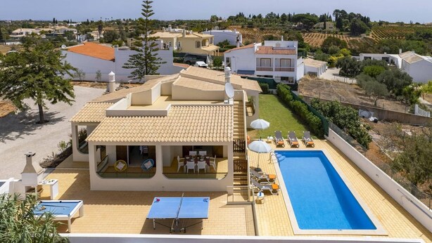A residential property with a swimming pool, outdoor seating, and a view of the surrounding landscape. - Villa Campos by Villa Plus (Guia)