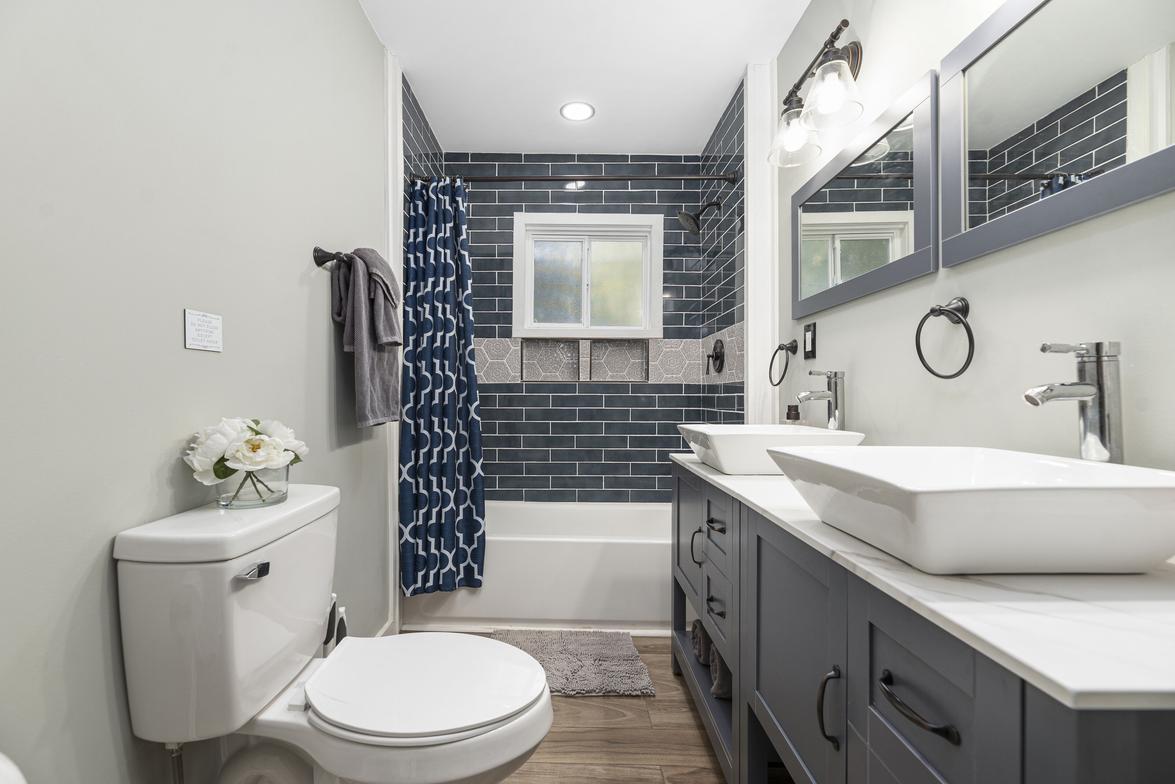 Bathtub, hair dryer, towels, shampoo