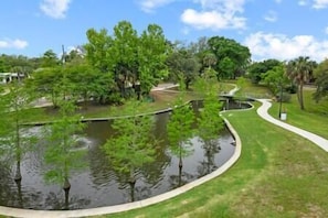 Escape to a serene oasis surrounded by lush greenery and a tranquil pond.