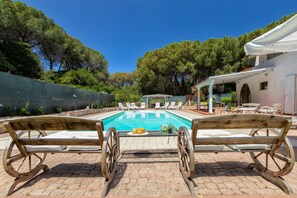 A poolside area with a wooden bench, lounge chairs, and a pergola. - Villa 'Matian' with Private Pool, Wi-Fi and Air Conditioning (marina di sorso)