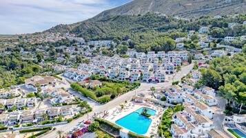 A residential area with a swimming pool surrounded by houses.
