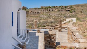 A stone pathway leading to a white building with a staircase.