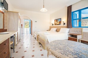 A hotel room with a bed, desk, and a view of the outdoors.