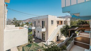 A multi-story building with a balcony, a staircase, and a view of the surrounding area. - Holiday Home 'Olympus Tilos Apt Twin A3 ' with Mountain View, Wi-Fi and Air Conditioning (Tilos)