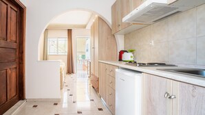 A kitchen with a dishwasher, a stove, and cabinets. - Holiday Home 'Olympus Tilos Apt Twin A3 ' with Mountain View, Wi-Fi and Air Conditioning (Tilos)