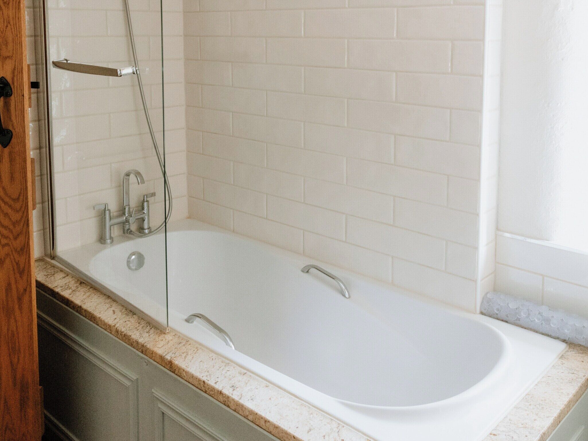A bathroom with a bathtub, a shower, and a sink.