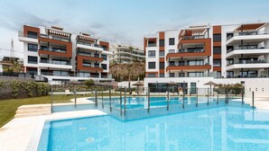 A modern residential building with a swimming pool, balconies, and a landscaped garden. - Apartment 'Holiday Apartment Middle Views' with Sea View, Wi-Fi and Air Conditioning (FUENGIROLA)