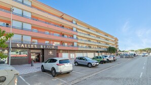 A multi-story hotel with a prominent sign reading 'Salles Beach Apartments.' - Apartment 'Salines' with Shared Pool, Balcony and Air Conditioning (Estartit)