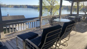 A covered outdoor seating area with a view of a lake, featuring metal chairs and a table. - Lakefront,  Great, wide-water views. Near bridge
 (Moneta)