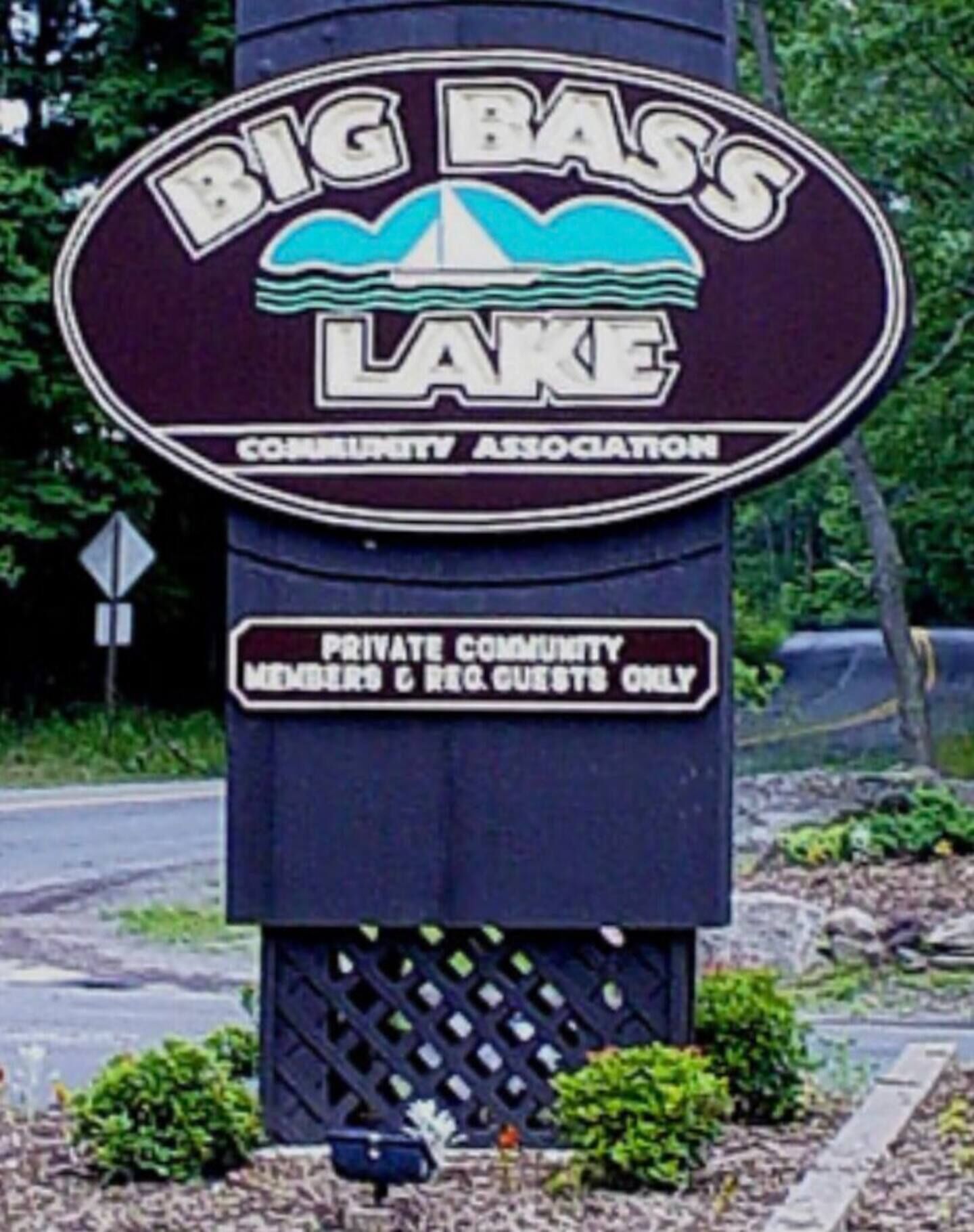 A sign for Big Bass Lake Community Association, indicating it is a private community for members and registered guests only.