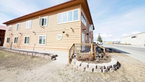 A two-story building with a flat roof and a wooden facade. - Rewak Studios (Fairbanks)