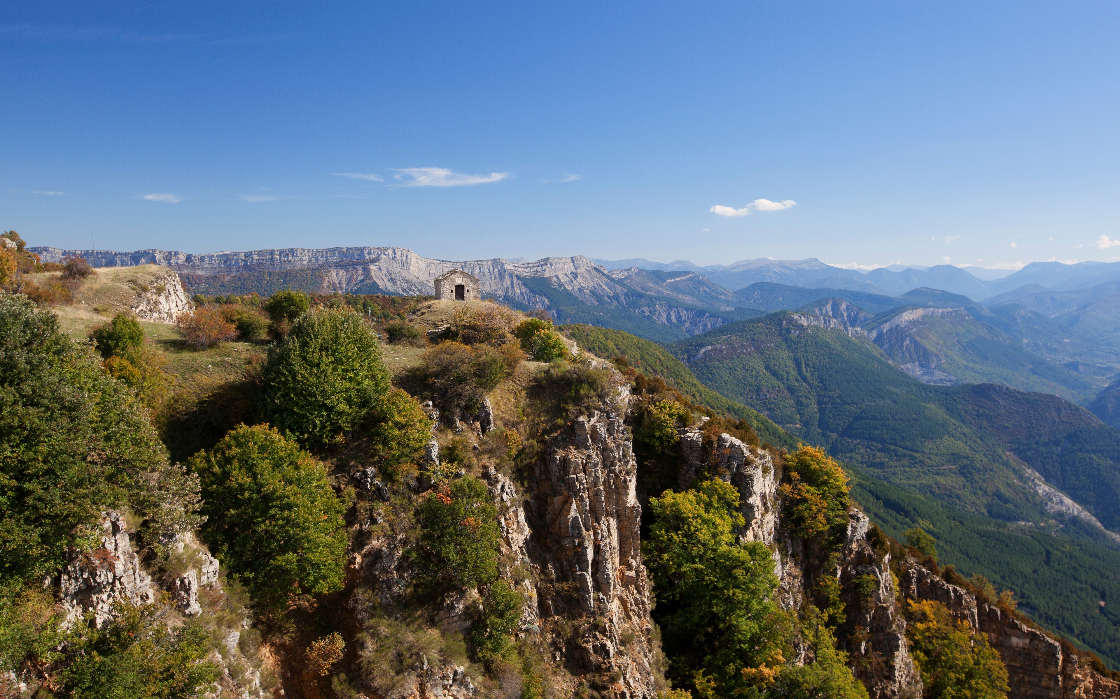 A mountainous landscape with rocky terrain and sparse vegetation.