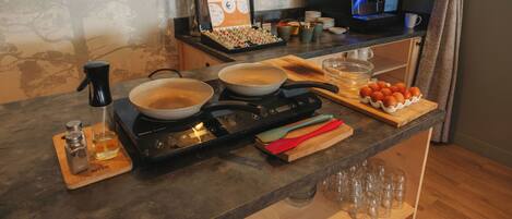 A kitchen counter with cooking utensils, a coffee machine, and a coffee pot.