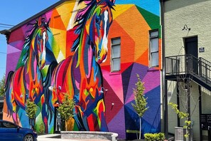 A building with a vibrant mural of horses on its facade.