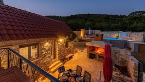 A stone house with a red-tiled roof, a pool, and outdoor seating. - Gorgeous home in Bruska with private swimming pool, can be inside or outside (Bruska)