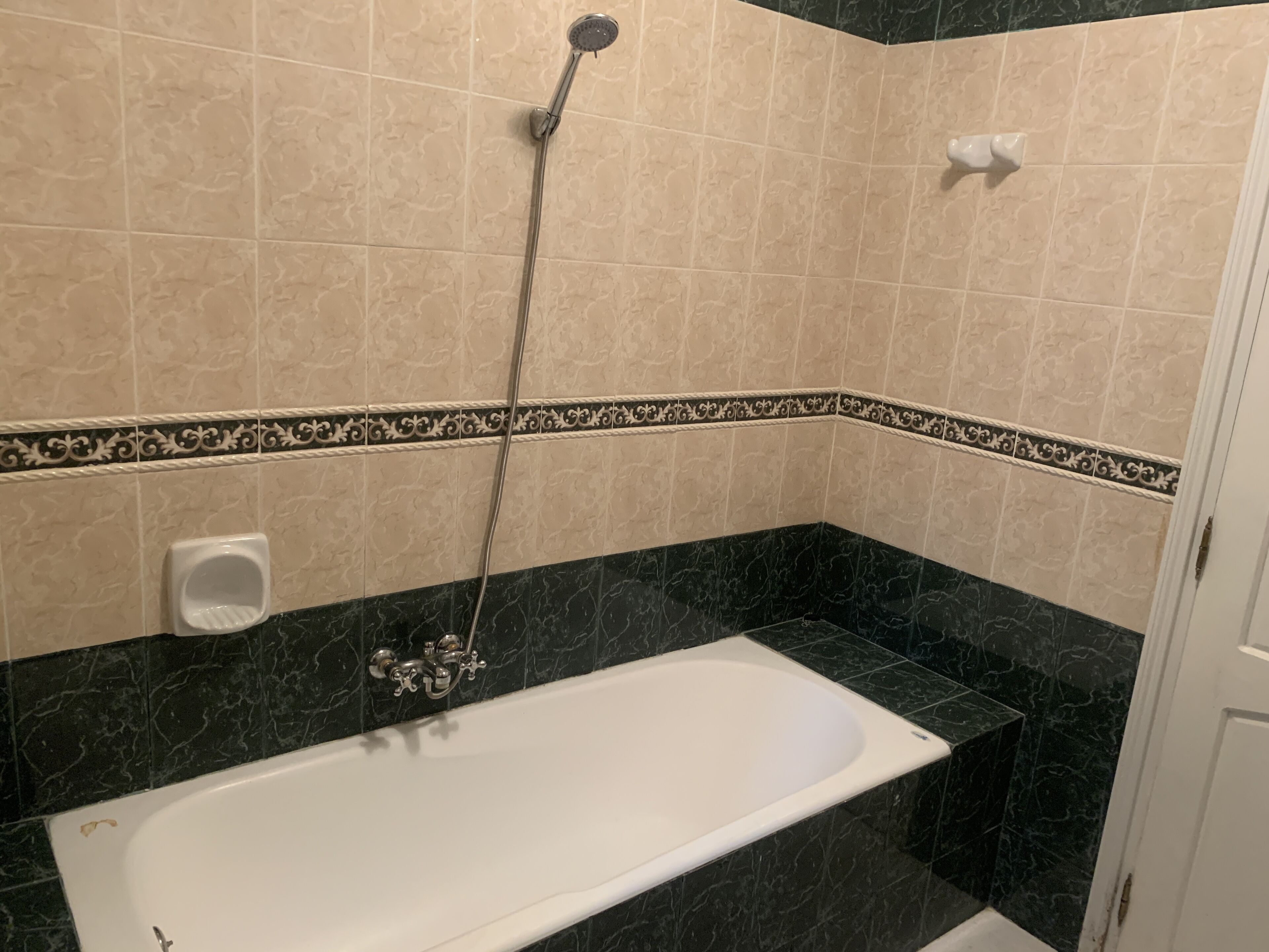 A bathroom with a bathtub, a shower, and a toilet.