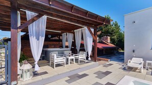 An outdoor patio with a hot tub, white furniture, and a pool. - Awesome home in Kapela with sauna (Kapela)